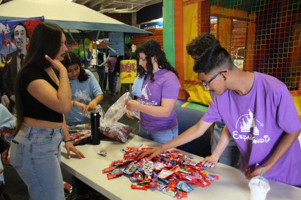 Booth attendees at Espanolandia provide treats and games for a day of fun.
