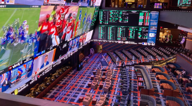 Screens display sports games as live bets are placed