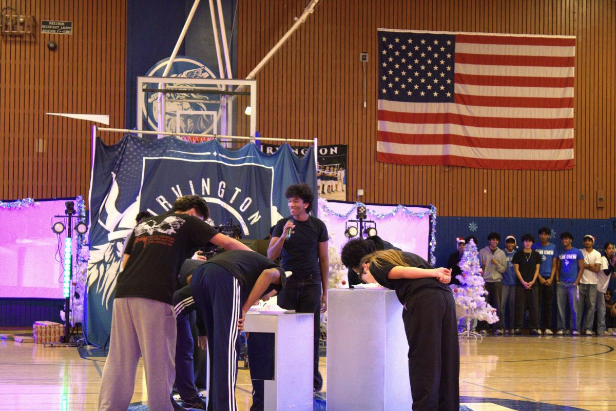 Students participating in the pie eating contest at Irvington’s 2025 Winter rally.