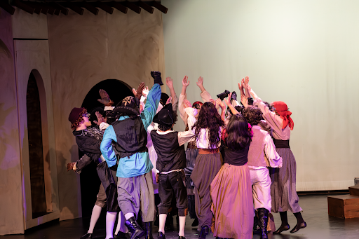 Student actors cheer together as part of choreographed pirate dance for the Caribbean twist on the classic Shakespearean play’s party scene.