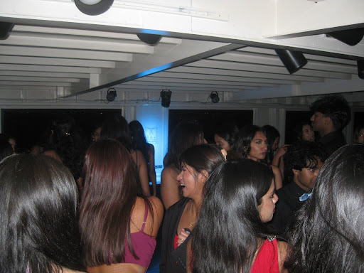 Seniors pack the dance floor aboard the cruise as music plays, filling the night with energy and celebration.