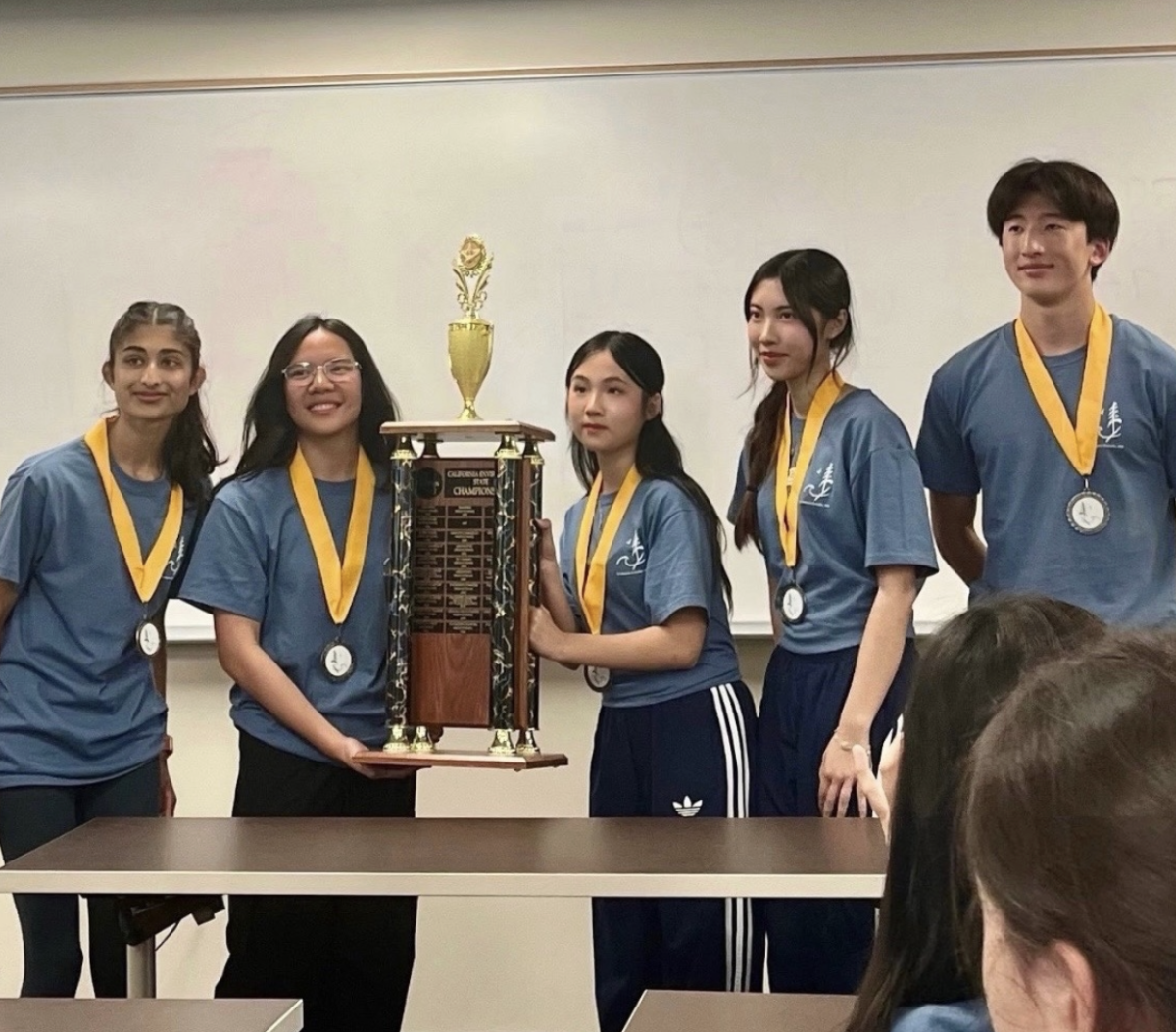From left to right: Geetika Maheshwari , Kelly Lock, Cynthia Yu, Mai-Ha Nghiem, and Alex Zhou pose with the first-place trophy.